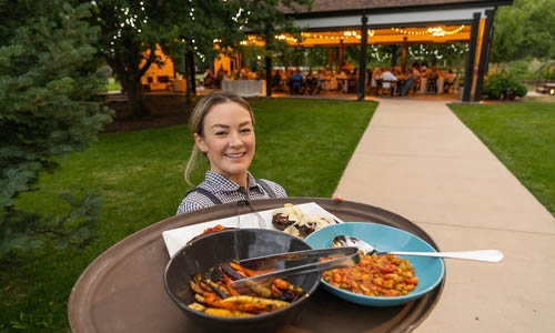 Catering staff holding tray of food